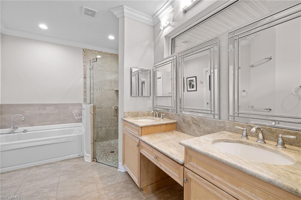 911 Mingo Drive Naples, FL 34120 - Photo 14 of 50 a bathroom with a granite countertop sink mirror and a bath tub