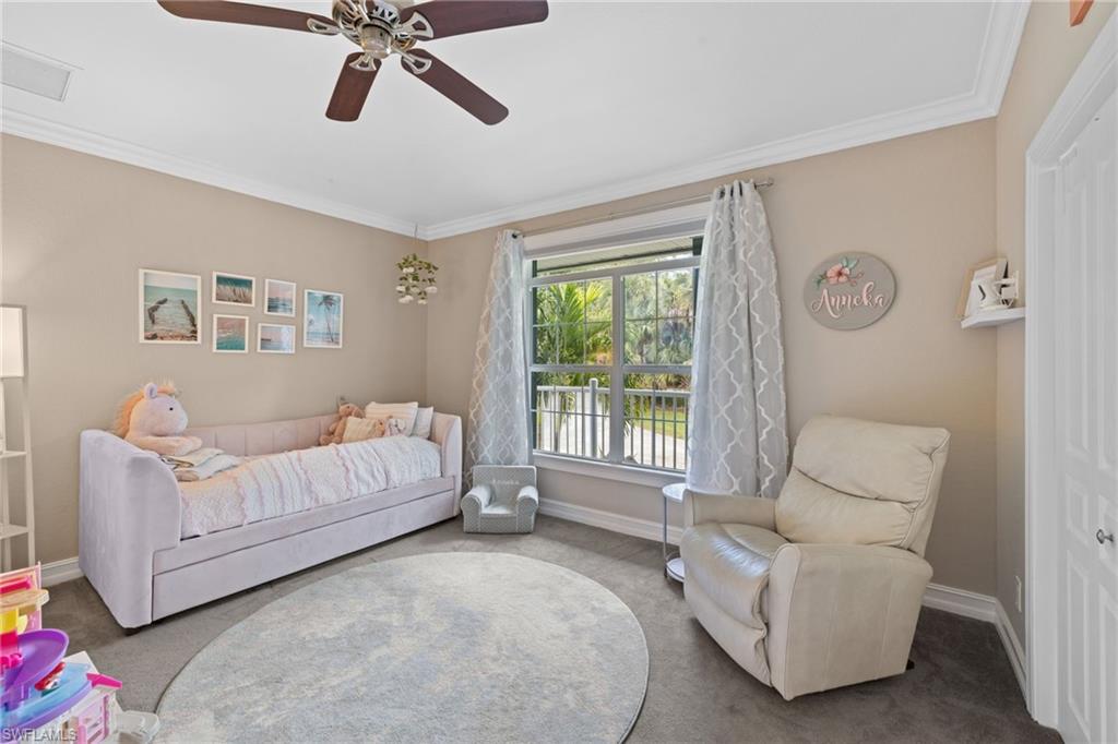 911 Mingo Drive Naples, FL 34120 - Photo 18 of 50 a spacious bedroom with a bed and a couch