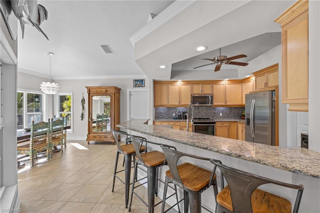 911 Mingo Drive Naples, FL 34120 - Photo 19 of 50 a large kitchen with granite countertop lots of counter space and windows