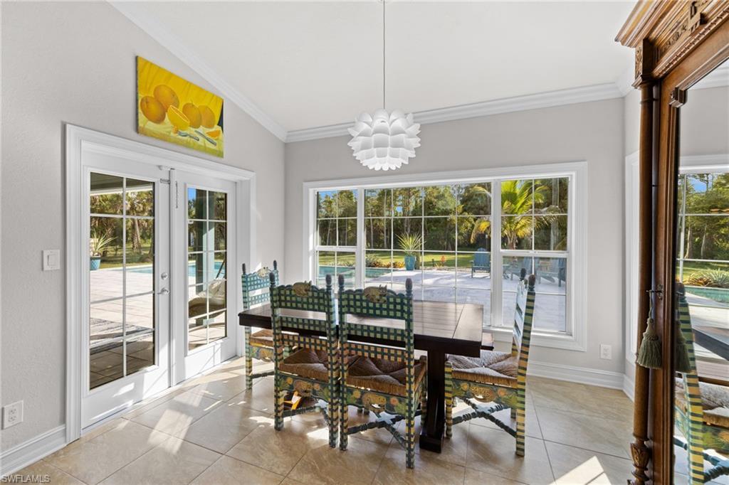 911 Mingo Drive Naples, FL 34120 - Photo 21 of 50 a view of a dining room with furniture window and outside view