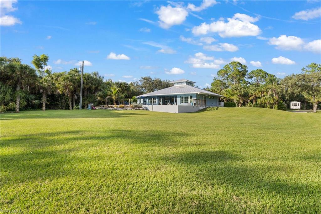 911 Mingo Drive Naples, FL 34120 - Photo 30 of 50 a view of a house with a big yard
