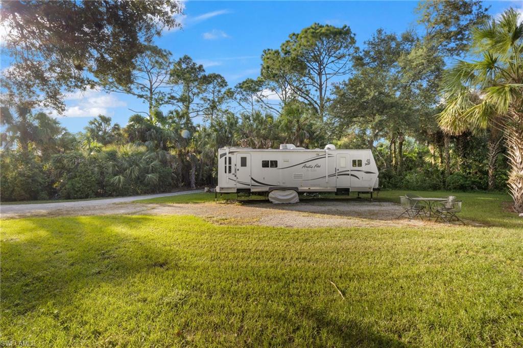 911 Mingo Drive Naples, FL 34120 - Photo 33 of 50 a view of a swimming pool with a yard