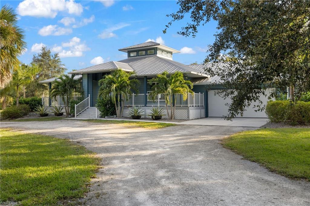 911 Mingo Drive Naples, FL 34120 - Photo 34 of 50 a view of a house with a yard and plants