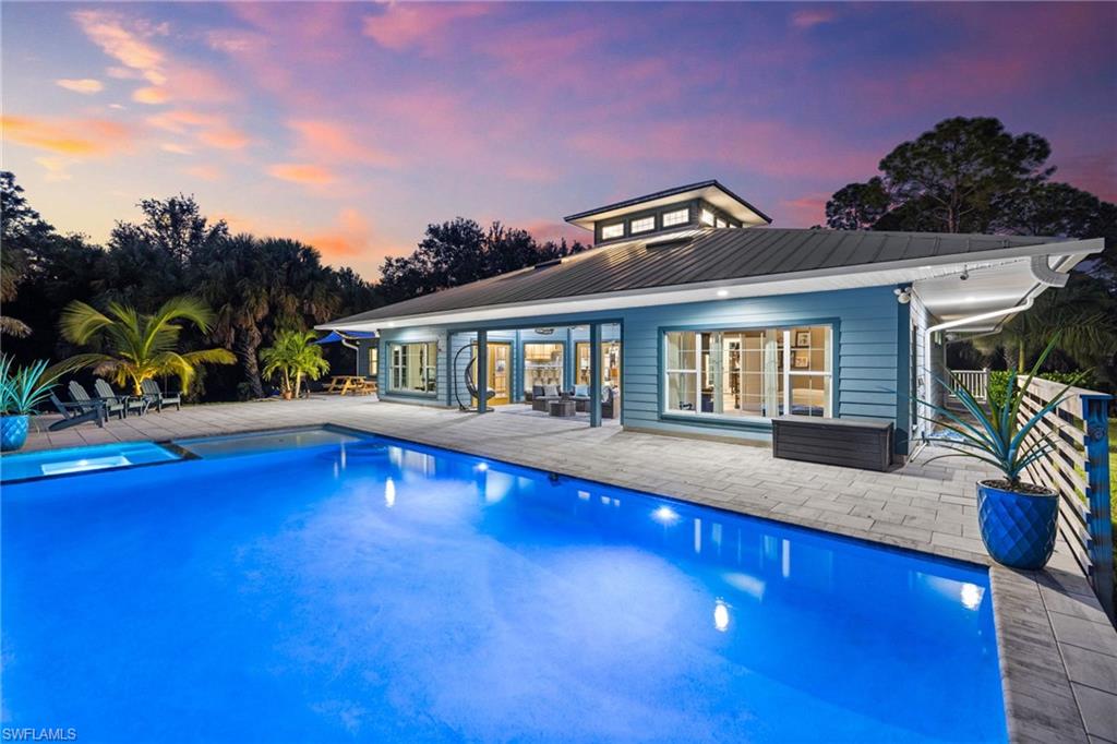 911 Mingo Drive Naples, FL 34120 - Photo 39 of 50 a view of a house with swimming pool and sitting area