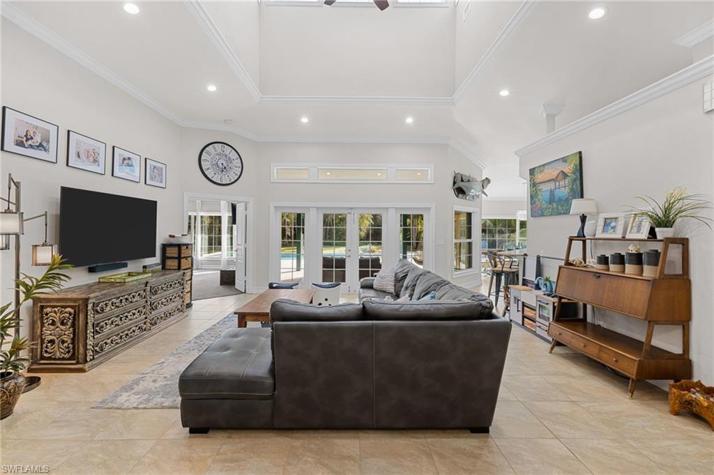 911 Mingo Drive Naples, FL 34120 - Photo 6 of 50 a living room with furniture and a flat screen tv