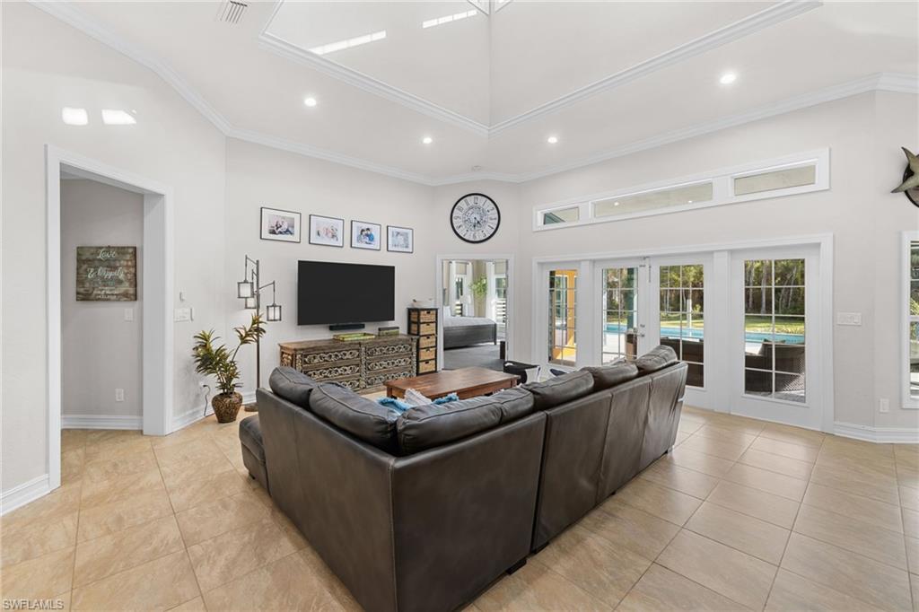 911 Mingo Drive Naples, FL 34120 - Photo 7 of 50 a living room with furniture and a flat screen tv