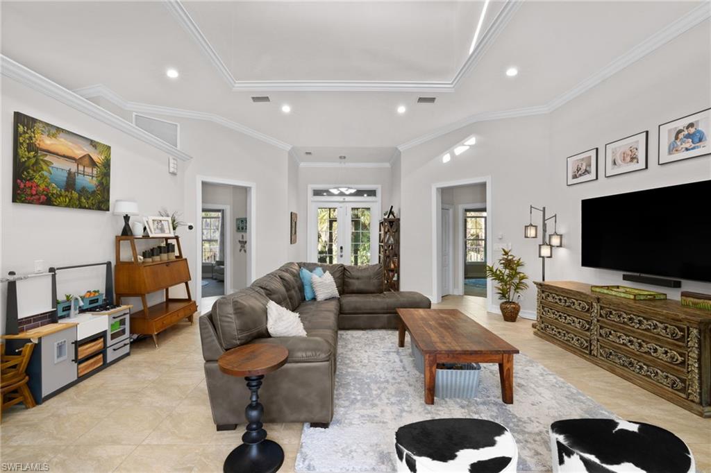 911 Mingo Drive Naples, FL 34120 - Photo 8 of 50 a living room with furniture and a flat screen tv