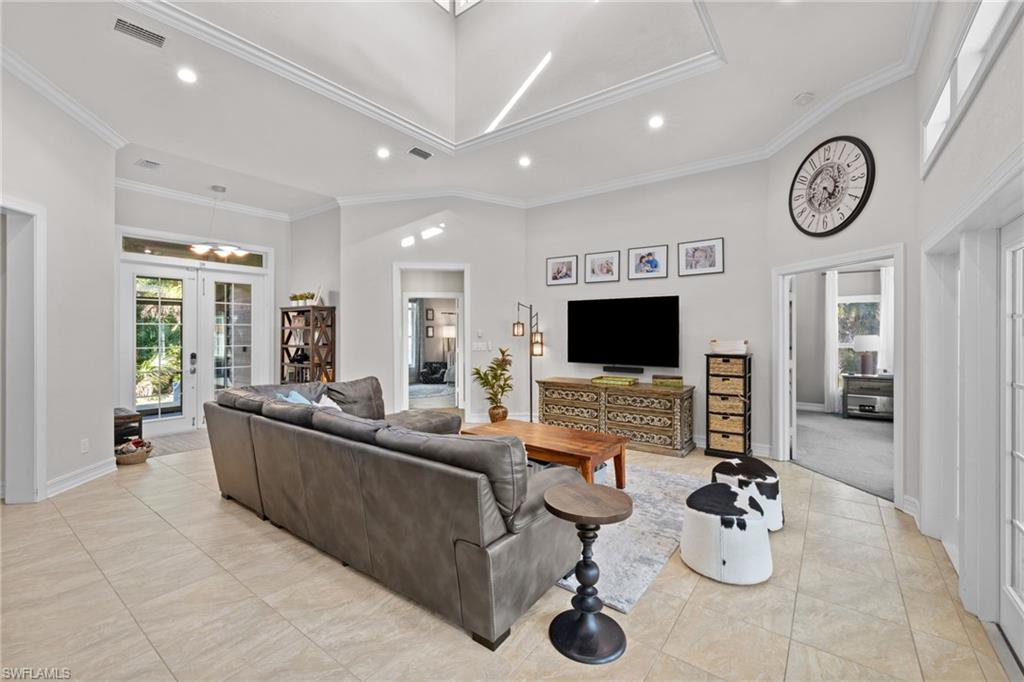 911 Mingo Drive Naples, FL 34120 - Photo 10 of 50 a living room with furniture and a flat screen tv