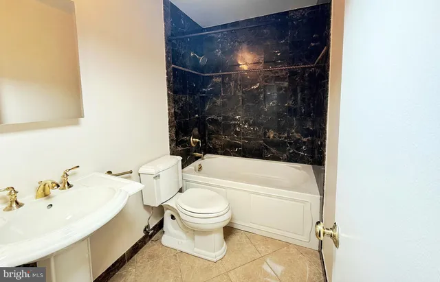 a bathroom with a bathtub and toilet