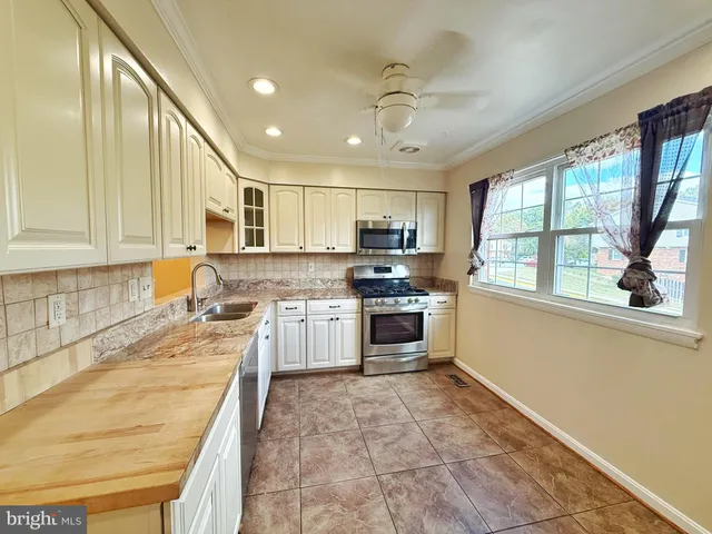 a kitchen with a stove a sink and a refrigerator