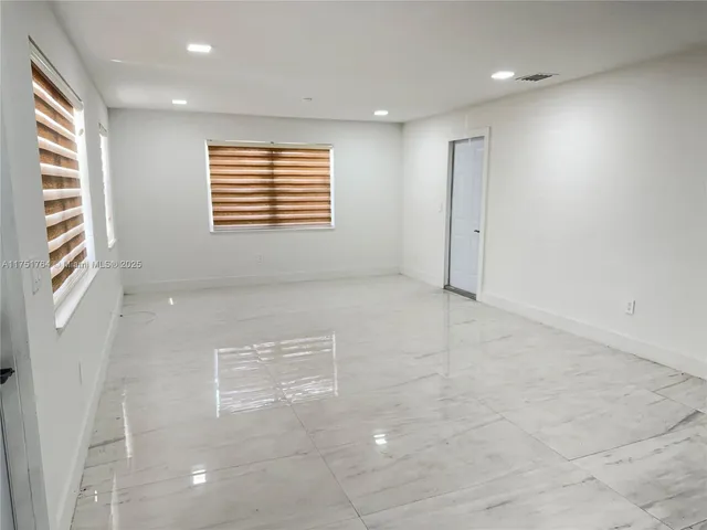 a bathroom with a sink a toilet a mirror and shower curtain
