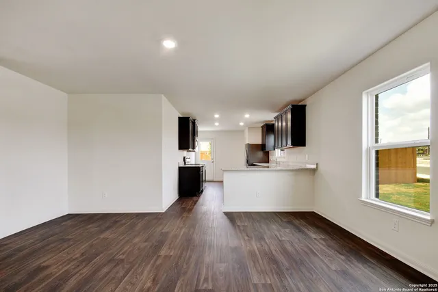 a view of kitchen with wooden floor and electronic appliances