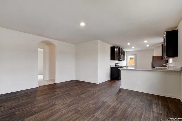 a view of kitchen with microwave and white cabinets