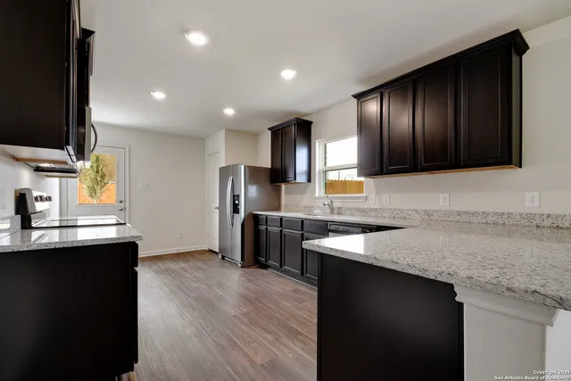 a kitchen with stainless steel appliances granite countertop counter space a sink and cabinets