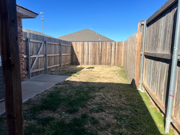 a view of backyard with small cabin