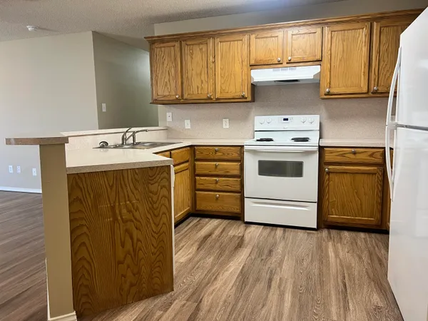 a kitchen with a stove sink and cabinets