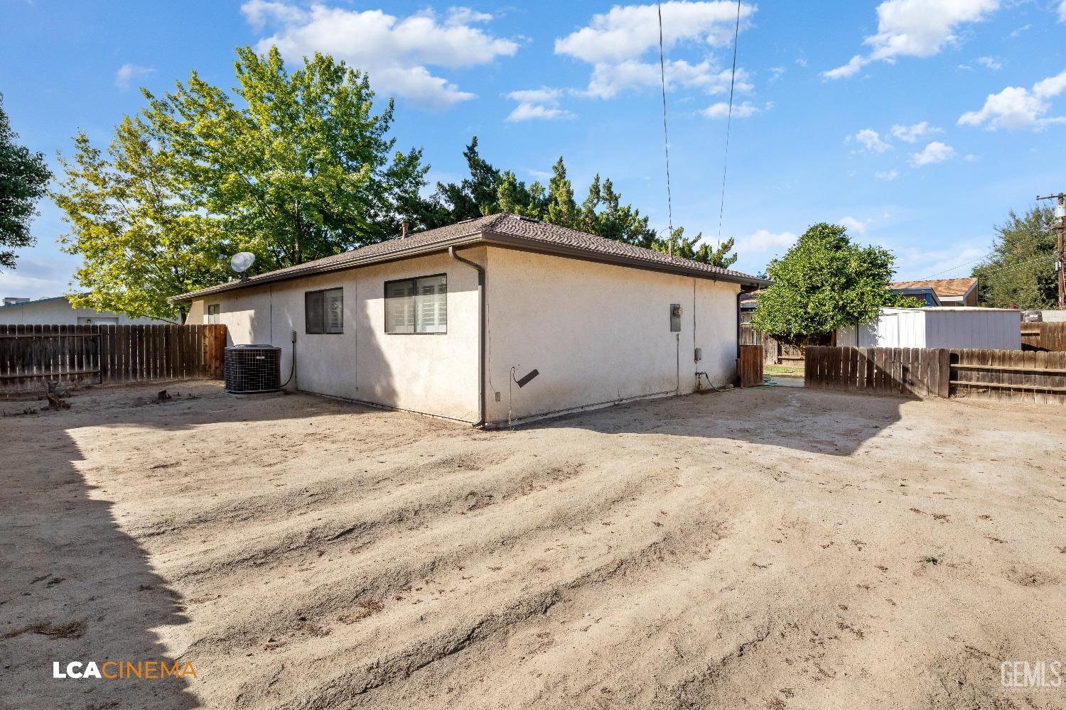 Undisclosed Address Shafter, CA 93263 - Photo 18 of 19 a view of a house with a yard and garage