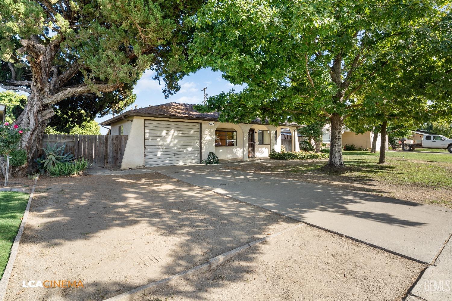 Undisclosed Address Shafter, CA 93263 - Photo 4 of 19 a front view of a house with a yard
