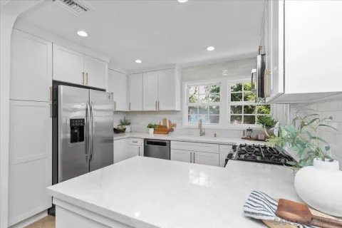 a kitchen with refrigerator and window