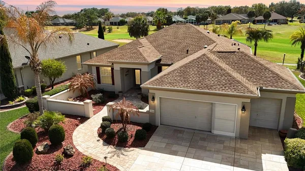 a aerial view of a house with a yard and balcony