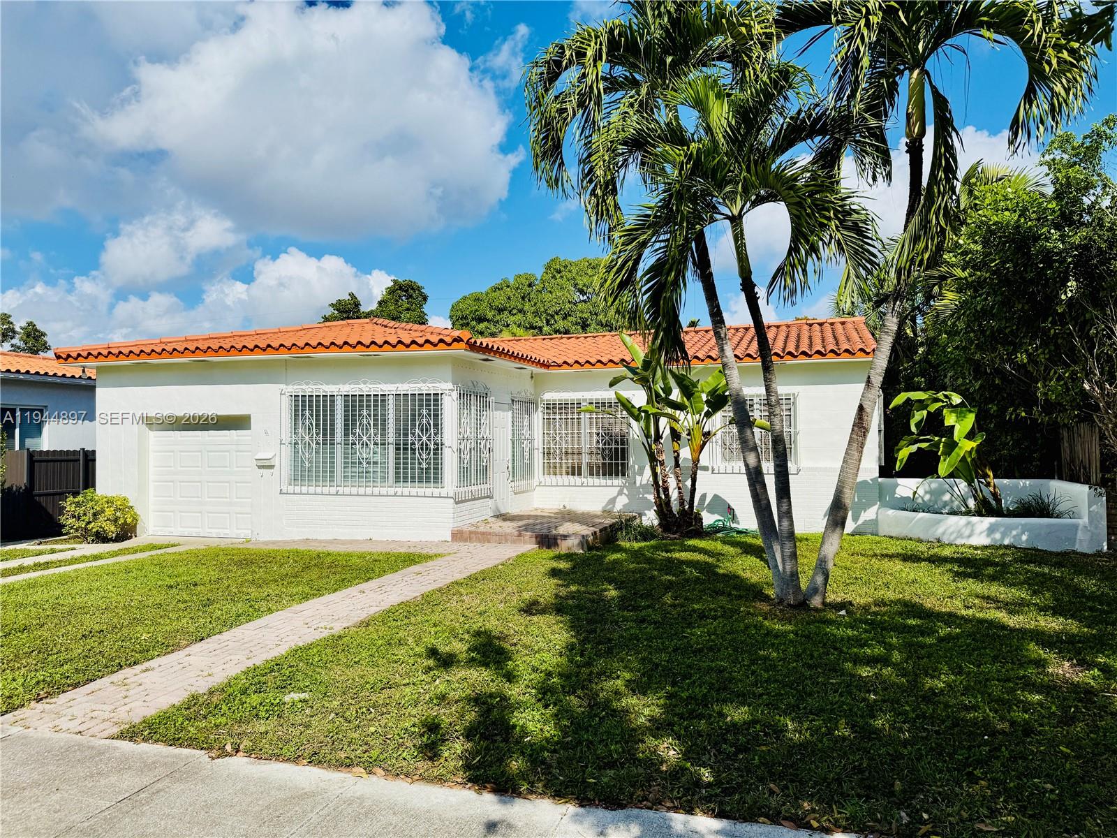 a view of a house with a yard and sitting area