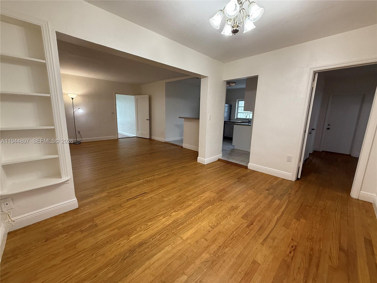 2151 Southwest 21st Terrace Miami, FL 33145 - Photo 15 of 22 a view of an empty room with wooden floor and a window
