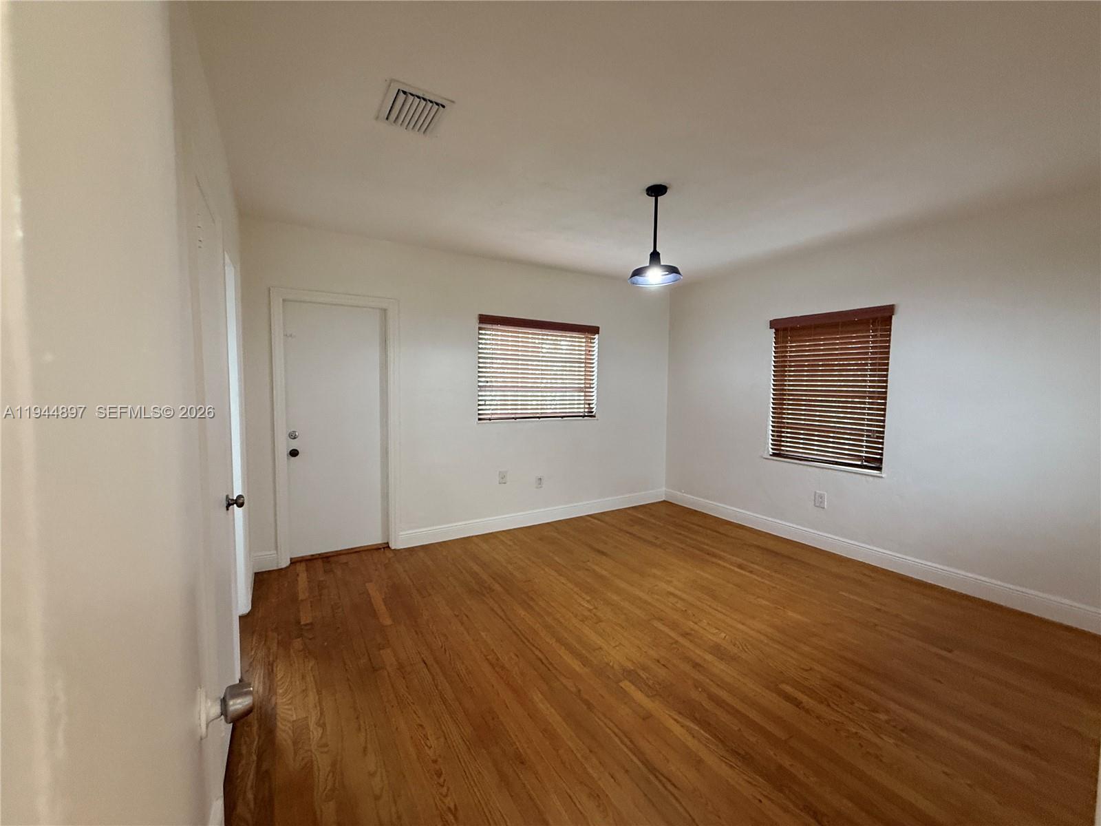 2151 Southwest 21st Terrace Miami, FL 33145 - Photo 16 of 22 a view of empty room with wooden floor and fan
