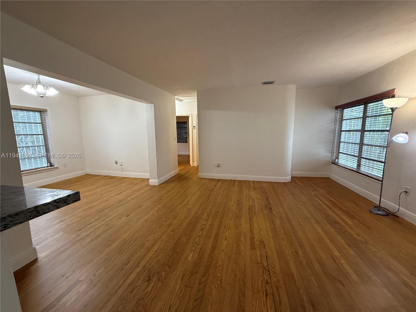 2151 Southwest 21st Terrace Miami, FL 33145 - Photo 9 of 22 an empty room with wooden floor and windows