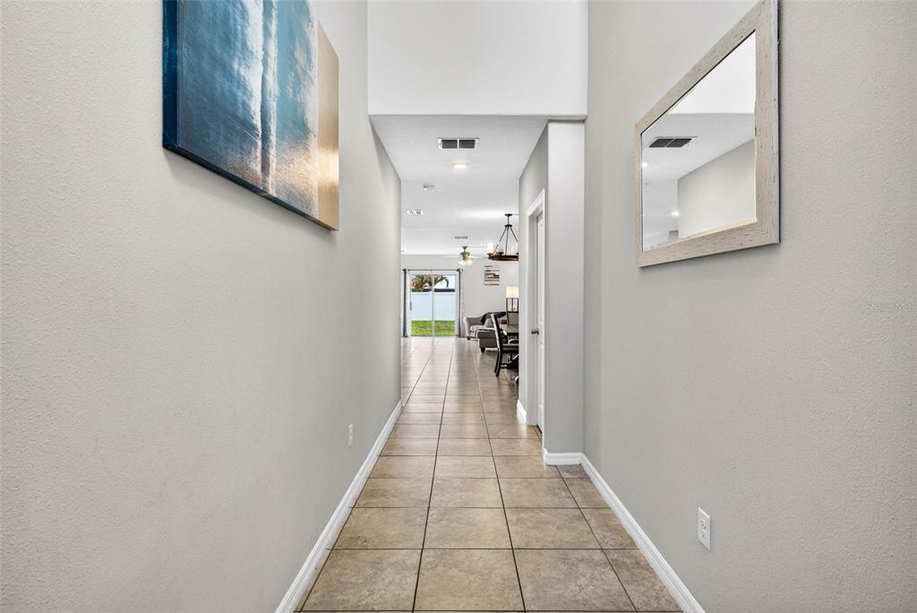 9616 Lemon Drop Loop Sun City Center, FL 33573 - Photo 7 of 53 a hallway with a view of a hallway
