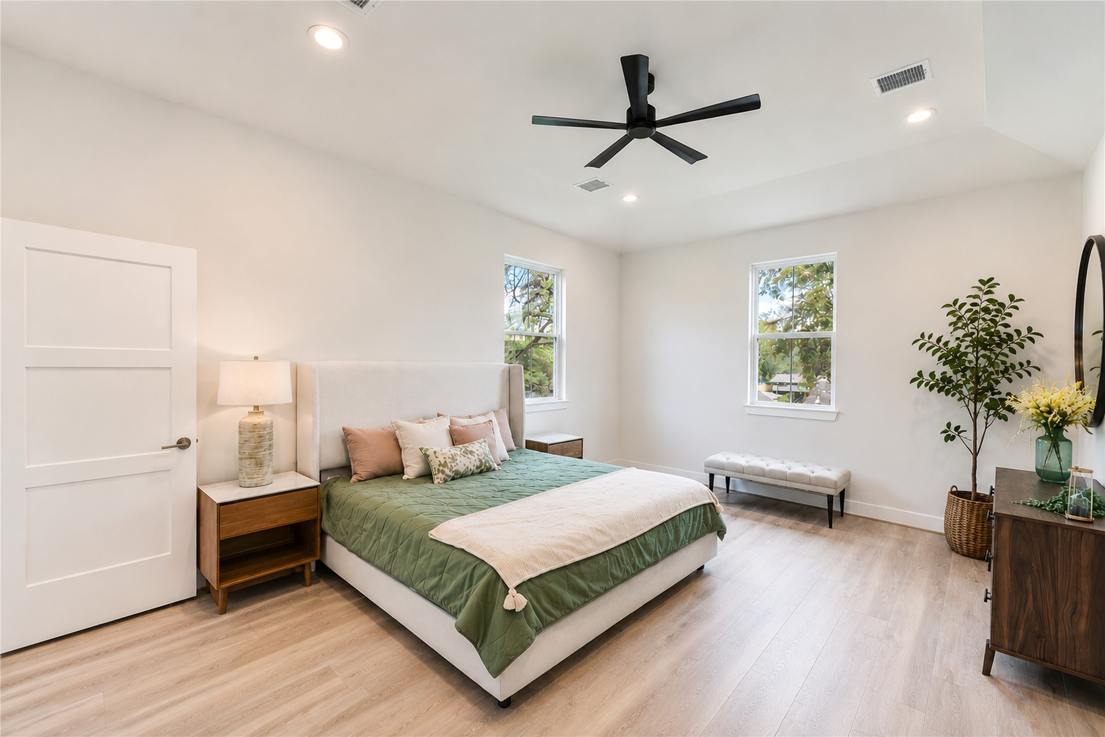 11104 Bauman Road Houston, TX 77076 - Photo 7 of 17 Primary Bedroom: Spacious and bright with modern finishes, wood-look flooring, and a relaxing, airy feel.