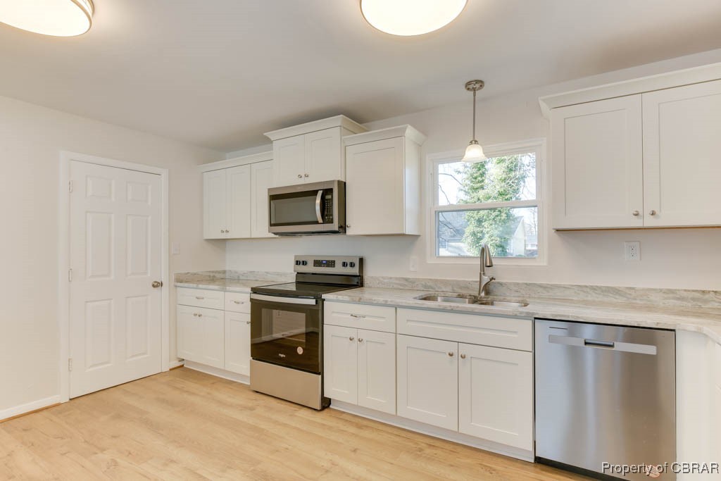 3310 West Weaver Road Hampton, VA 23666 - Photo 11 of 28 a kitchen with white cabinets appliances and a sink