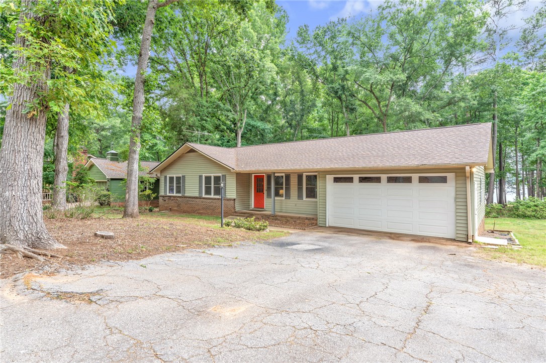 4416 Denver Cove Road Anderson, SC 29625 - Photo 1 of 31 A classic ranch home nestled among mature trees with a convenient attached garage.