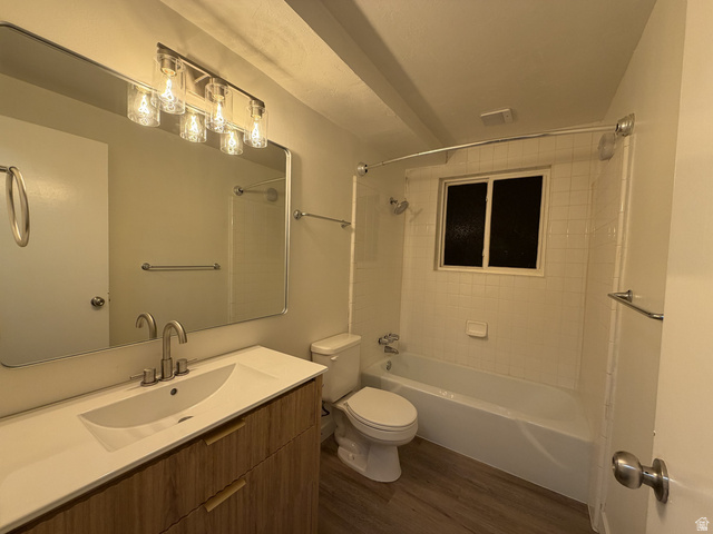 895 East Arrowhead Lane Murray, UT 84107 - Photo 5 of 12 Contemporary bathroom featuring a wood-finish vanity with an integrated white sink and a large rectangular mirror
