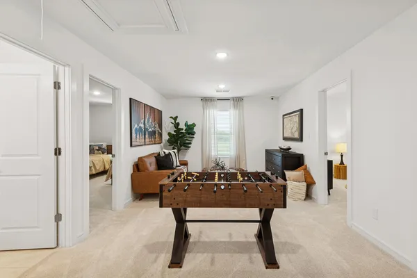 a bedroom with a bed and a chair