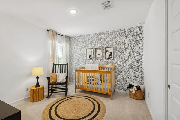 a spacious bedroom with two beds and a window