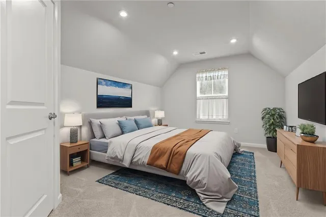 a spacious bedroom with a bed a couch and a potted plant