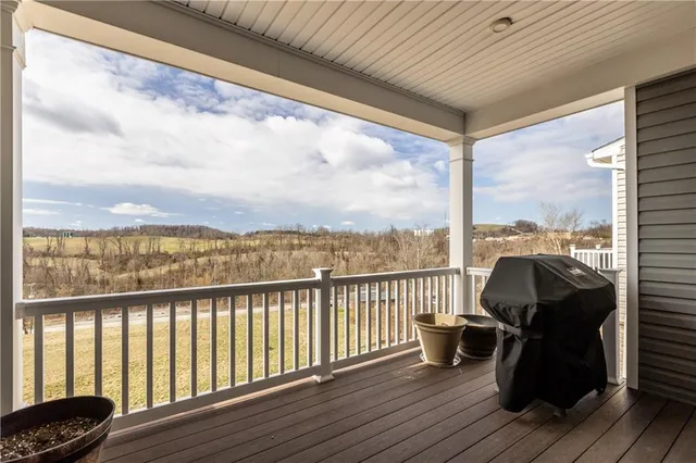 a view of a balcony with wooden floor
