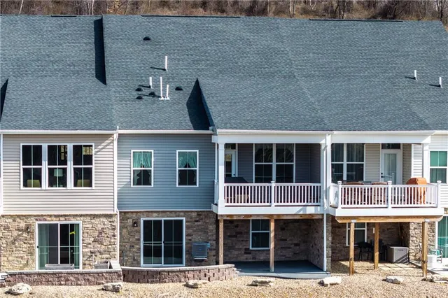 an aerial view of a house with swimming pool and sitting area
