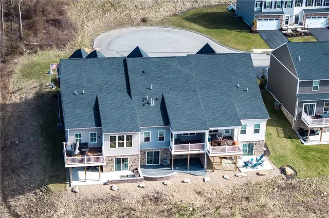 an aerial view of a house with a yard and lake view