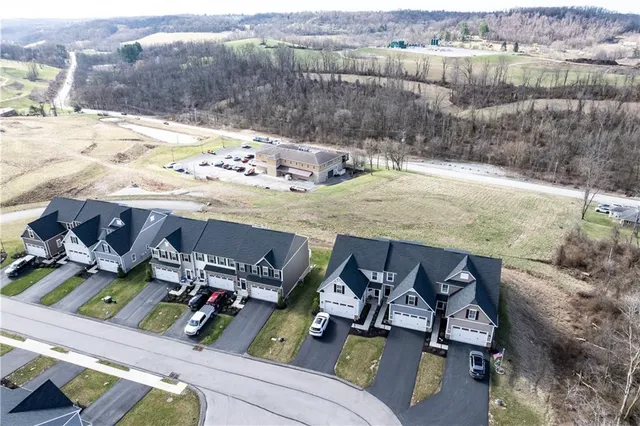 an aerial view of residential houses with outdoor space