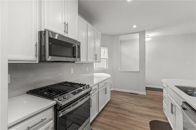 a kitchen with a stove and a microwave