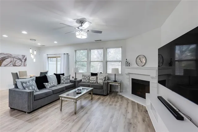 a living room with furniture a fireplace and a flat screen tv