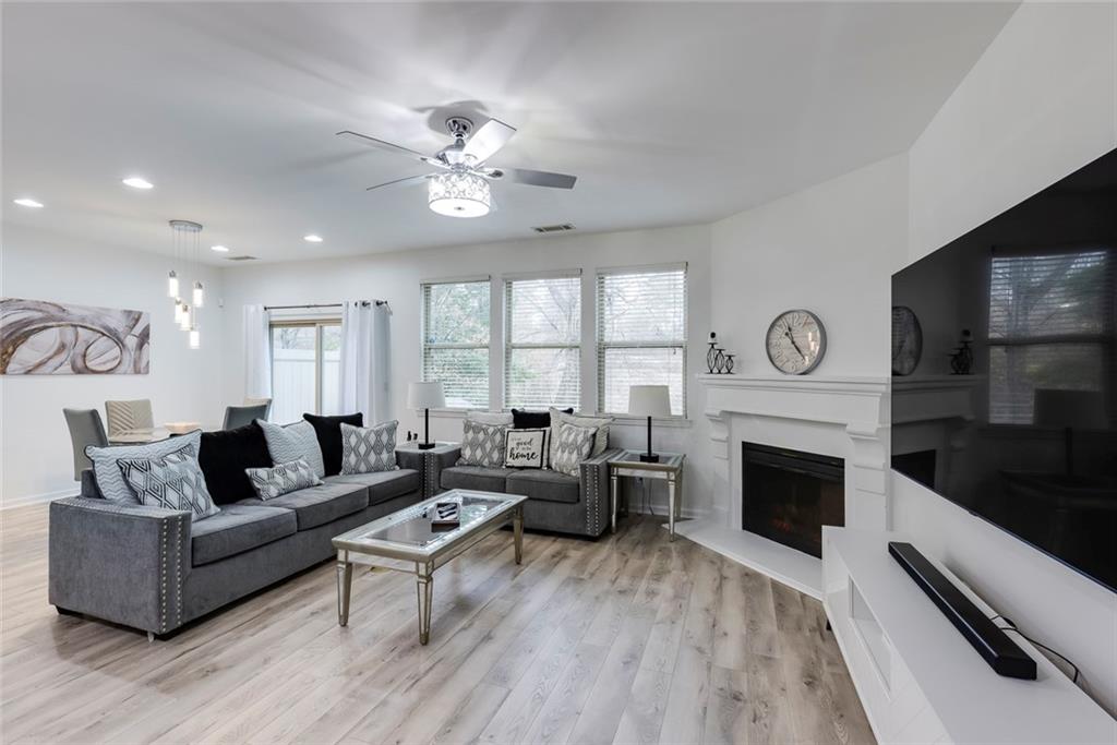 1561 Trailview Way Northeast Atlanta, GA 30329 - Photo 12 of 38 a living room with furniture a fireplace and a flat screen tv