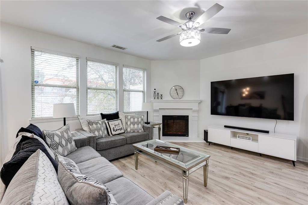 1561 Trailview Way Northeast Atlanta, GA 30329 - Photo 13 of 38 a living room with furniture a flat screen tv and a fireplace