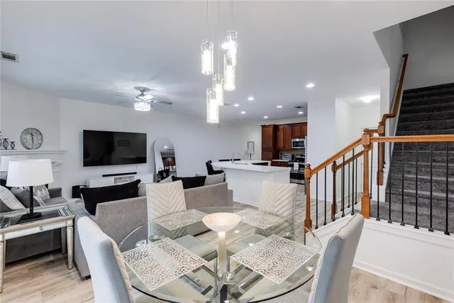 a living room with furniture kitchen view and a flat screen tv