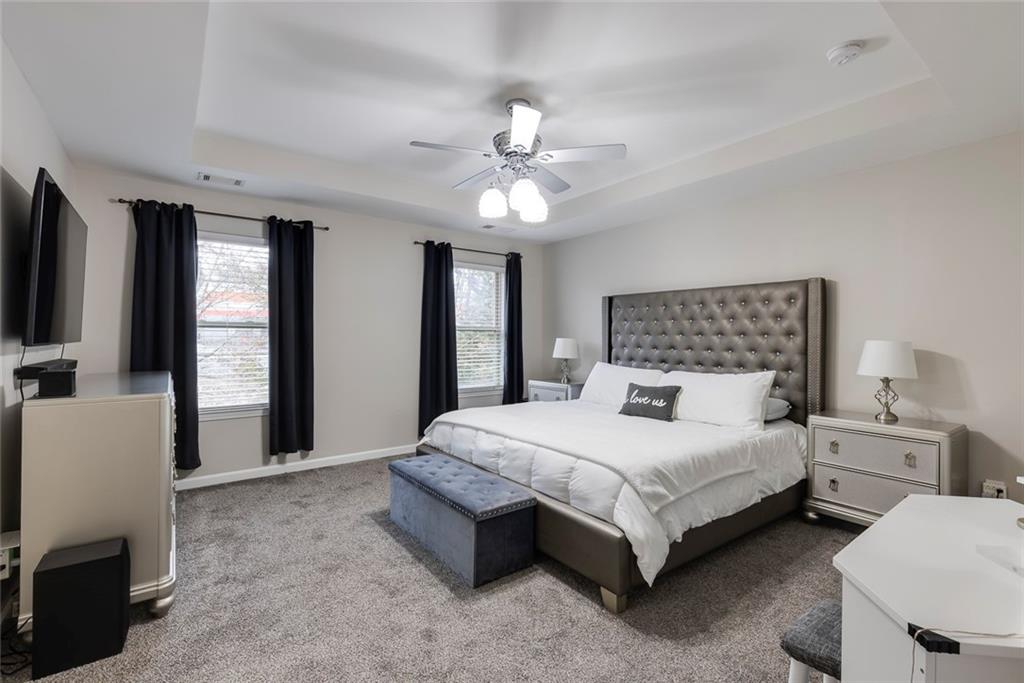 1561 Trailview Way Northeast Atlanta, GA 30329 - Photo 18 of 38 a bedroom with a bed couch and a flat tv screen