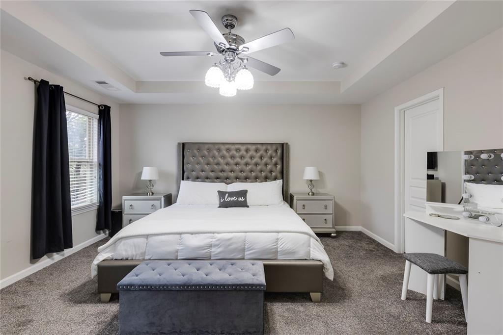 1561 Trailview Way Northeast Atlanta, GA 30329 - Photo 19 of 38 a bedroom with a large bed and a chandelier