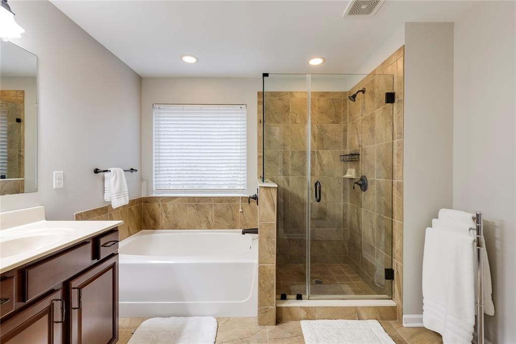 1561 Trailview Way Northeast Atlanta, GA 30329 - Photo 21 of 38 a bathroom with a bath tub a mirror and a shower