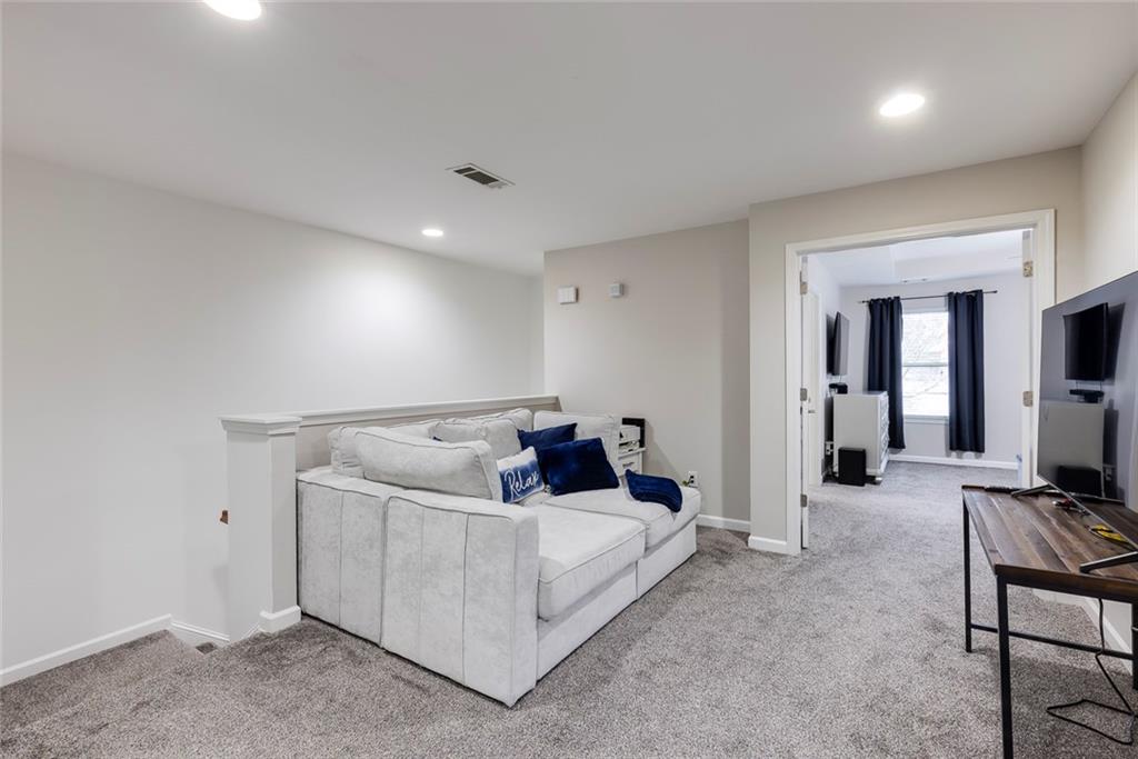 1561 Trailview Way Northeast Atlanta, GA 30329 - Photo 23 of 38 a living room with furniture and a flat screen tv