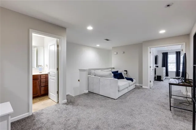 a bed room with furniture and mirror